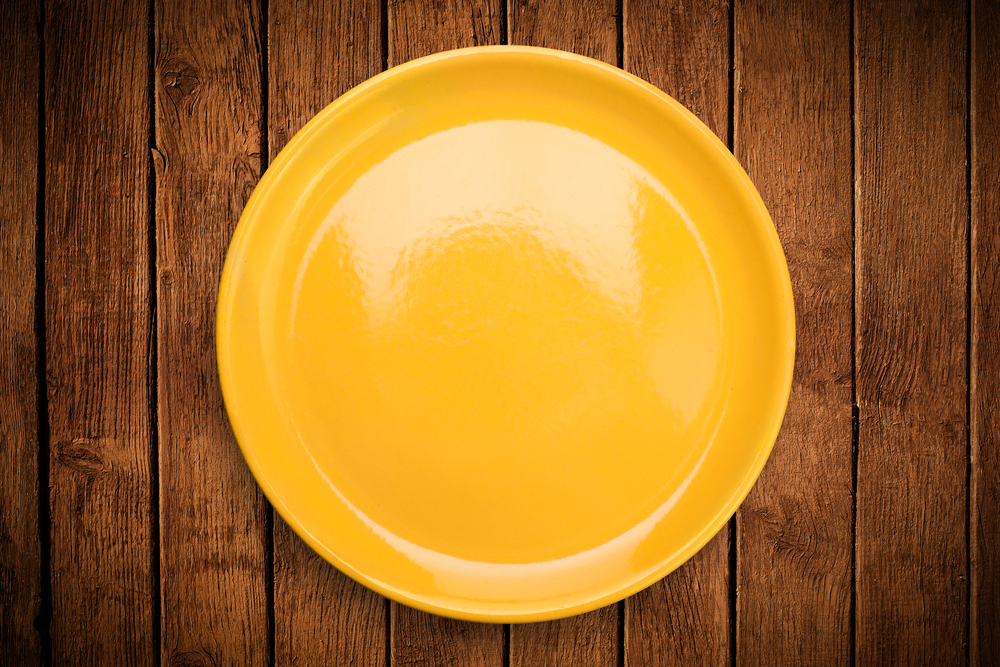 Colorful empty shiny plate on grungy background table