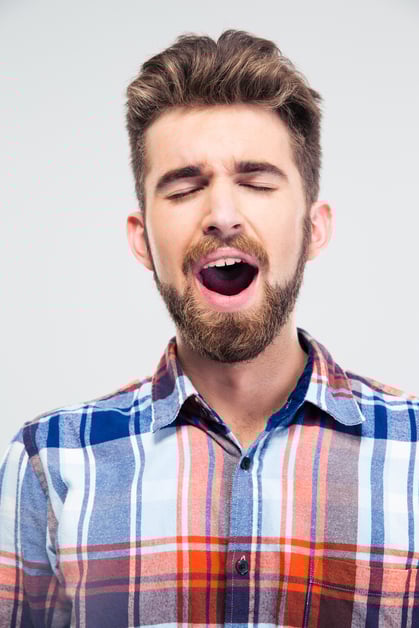 Portrait of a young man singing with closed eyes isolated on a white background
