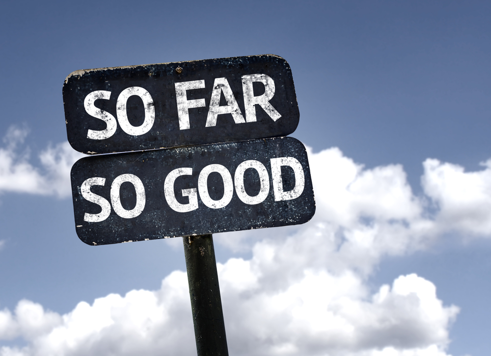 So Far So Good sign with clouds and sky background